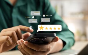 Person's hands holding a phone with graphical 5 star reviews